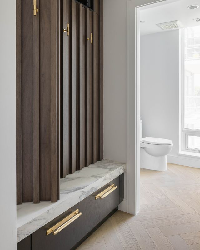 Who said hallways had to be boring? Add depth and style to any space with custom-built cabinetry. Fume on walnut, marble, and gold make for the most elegant decor. 

Cabinetry: Fume on Flat Cut Walnut,  New Haven door style
Designer: @thomasandbirchboutique x @justin.tse
Dealer: Thomas and Birch Boutique
Photographer: @jonathanfolk.ca 

#ExperienceElmwood #ElmwoodCabinets #ElmwoodCabinetry #CustomCabinetry #LuxuryDesign #DarkDesign #Greydecor #Moodydecor #Decor #Homedesign #Interiordesigner #Marbledesign