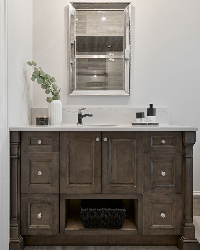 These dark wood tones bring rustic traditional charm to this bathroom and match perfectly with this elegant marble countertop. Achieve a timeless bathroom look that exudes sophistication.

Cabinetry: Driftwood on Maple, Maranello door style
Dealer: Artisan Kitchen and Bath 
Designer: Artisan Kitchen and Bath Team & Jennifer Renwick 
Photographer: @alexouzilleau

#Elmwood  #cabinetry #cabinets #rusticbathroom
