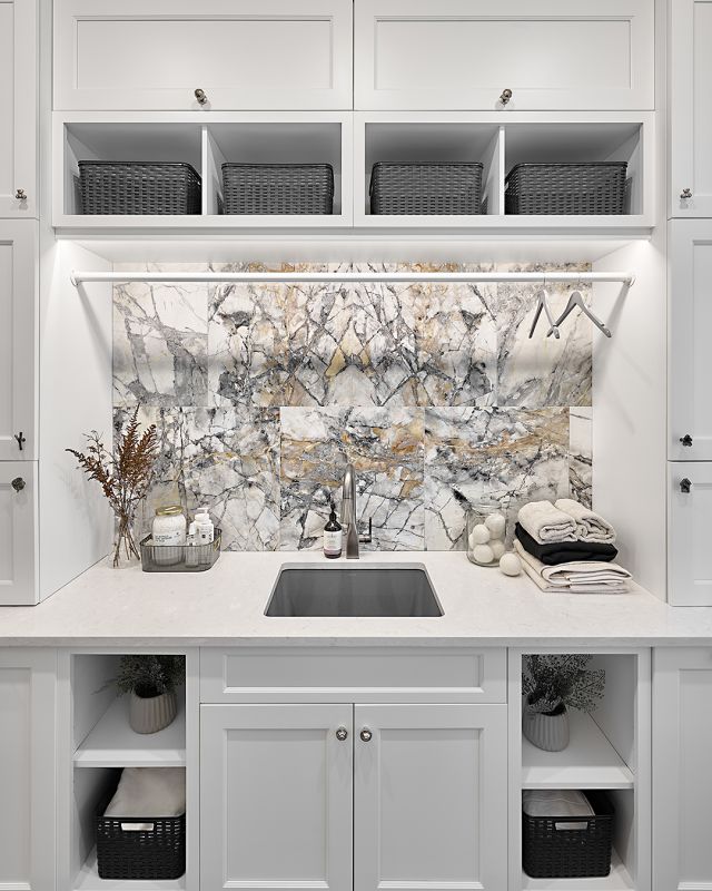 Transform your laundry room into a sanctuary of luxury with a stunning marble backsplash and crisp white cabinetry. Elevate the space with sophistication and style, making even laundry feel like a lavish experience. 

Dealer: Artisan Kitchen and Bath 
Designer: Artisan Kitchen and Bath Team & Jennifer Renwick 
Photographer: @alexouzilleau 

#Elmwood  #cabinetry #cabinets #customcabinetry #modernlaundry