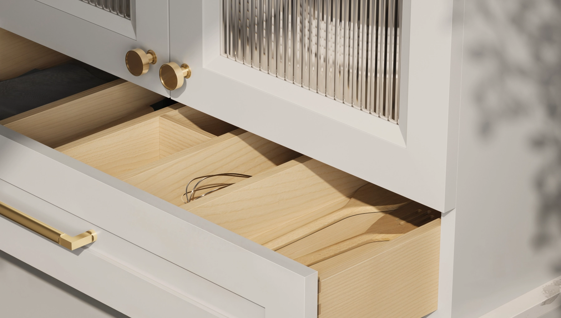 Custom kitchen drawer in Nantucket Grey maple by Cabico, with solid wood interior, gold pull, and fluted glass cabinets above.