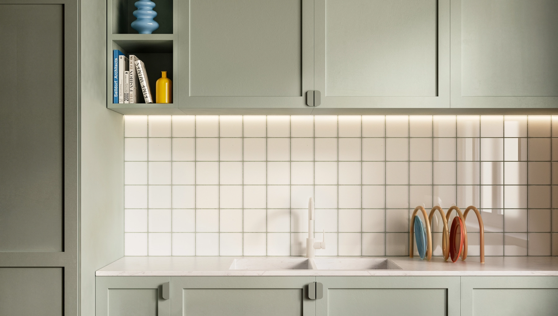Close-up of Essence kitchen cabinet in Kaffa door style, painted in Serene Sage. Frameless, matte finish cabinetry with open shelving and a subtle retro tile backdrop.