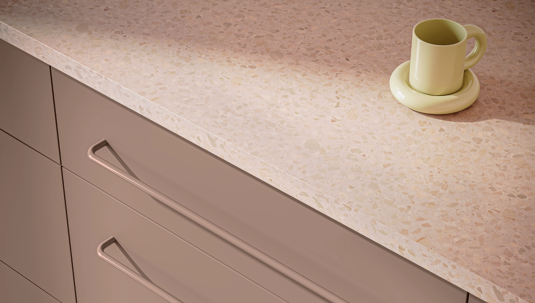 Close-up of frameless Essence kitchen cabinet in Modena style, painted in Brioche pink. Features tone-on-tone pink handles for a playful, modern look.